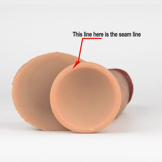 Close-up of silicone dildo suction cup base with red arrow pointing to the mold seam line — RealTouch Lab seam line material test guide