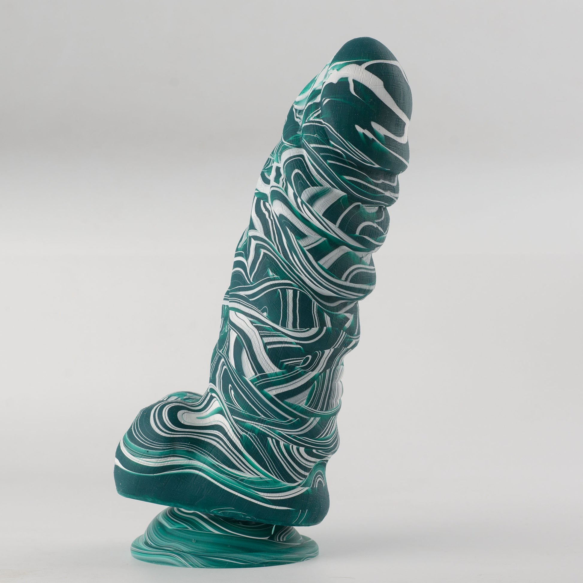 Griffin Fantasy Collection silicone dildo - 45-degree front side view standing on suction cup base showing teal and white marble swirl colorway, fantasy rounded tip, bold horizontal ridge segments along shaft creating pronounced texture pattern and flared base - body-safe platinum-cured single-density silicone | RealTouch Lab
