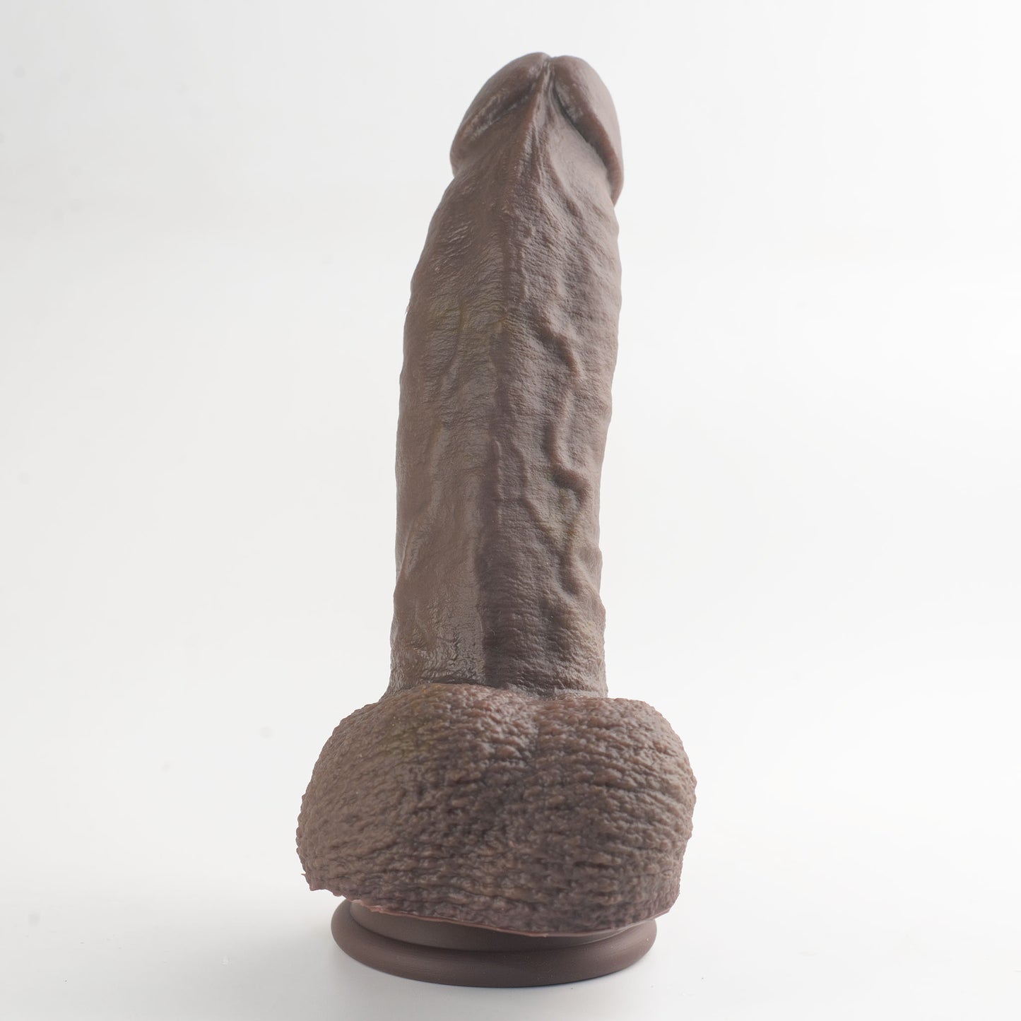Stage 03 Giganotosaurus dual-density silicone dildo - base and scrotum view showing intricate texture details in dark brown colorway - body-safe platinum-cured | RealTouch Lab

