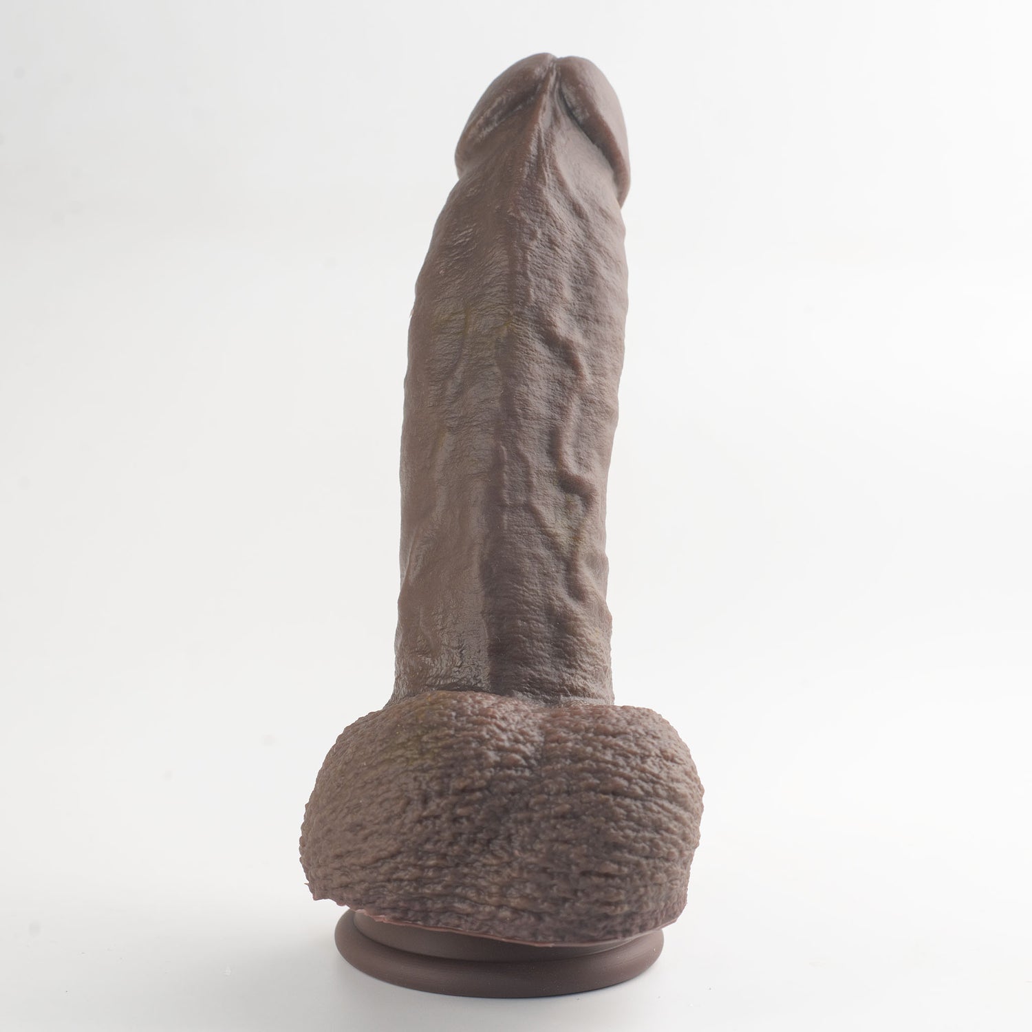 Stage 03 Giganotosaurus dual-density silicone dildo - base and scrotum view showing intricate texture details in dark brown colorway - body-safe platinum-cured | RealTouch Lab

