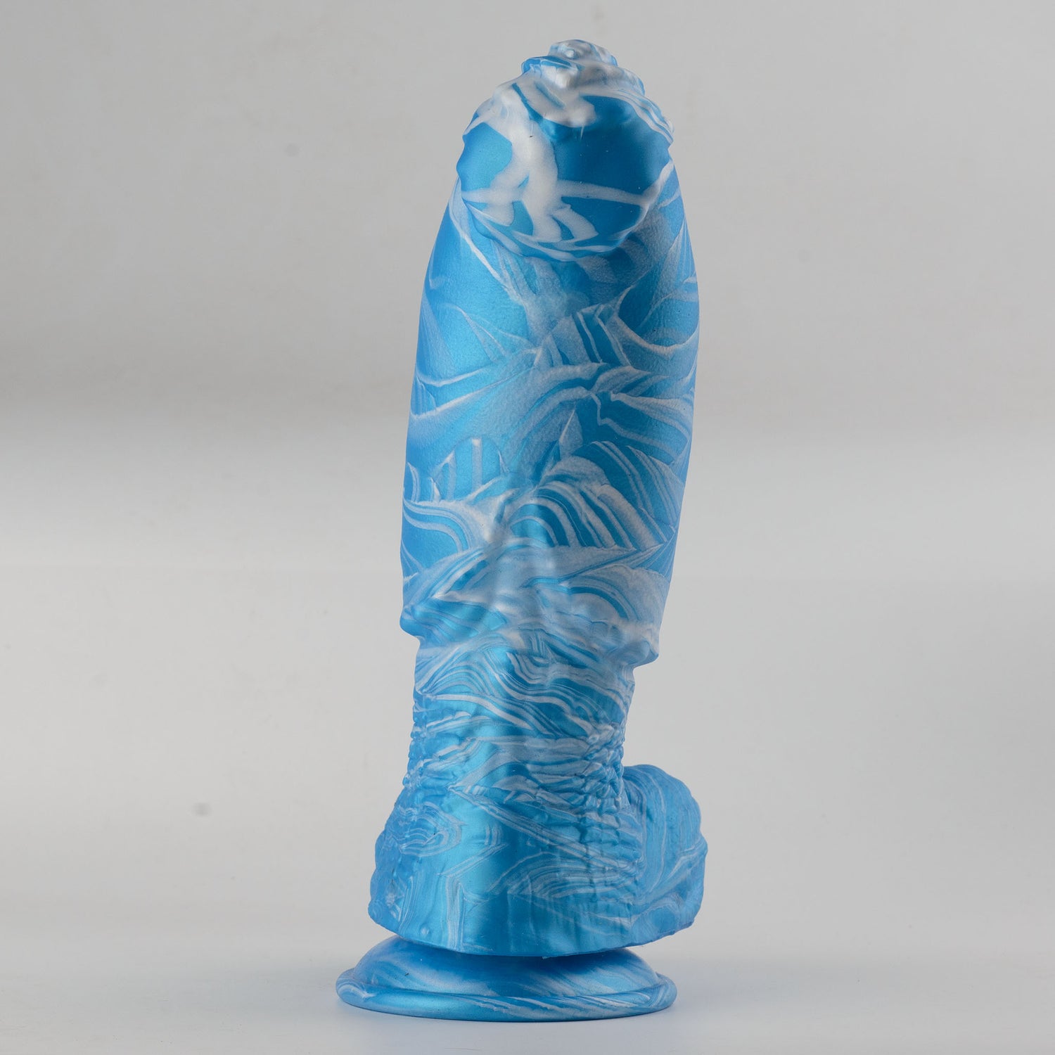 Kraken Fantasy Collection silicone dildo - full front view standing on suction cup base showing ice blue and white lightning crack marble swirl colorway with fantasy rounded tip, organic irregular crack-pattern surface texture along full shaft and full scrotum above suction cup base - body-safe platinum-cured single-density silicone | RealTouch Lab
