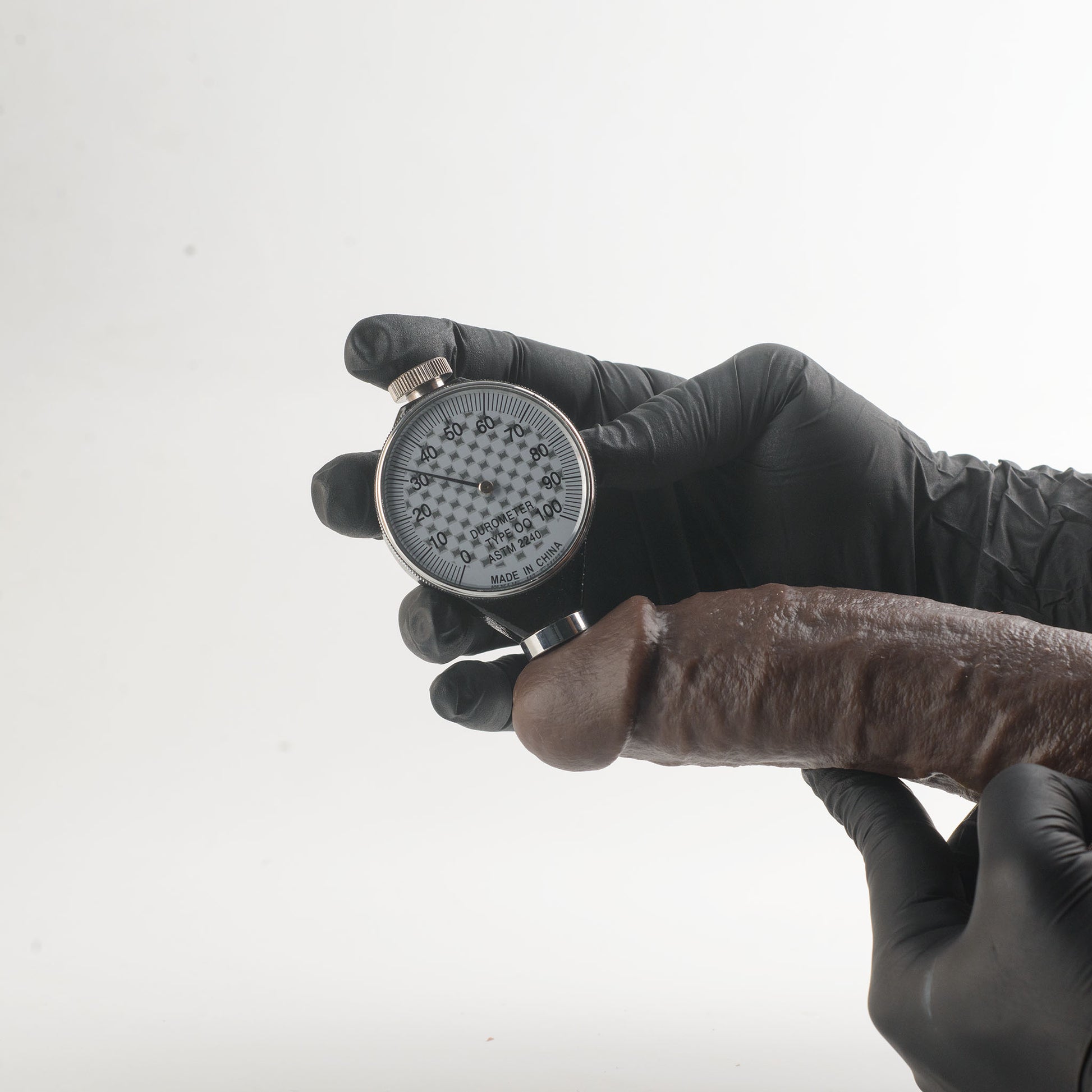 Stage 03 Giganotosaurus dual-density silicone dildo - Shore 00 durometer hardness test showing approximately 30-35 Shore 00 softness rating on outer layer - body-safe platinum-cured | RealTouch Lab
