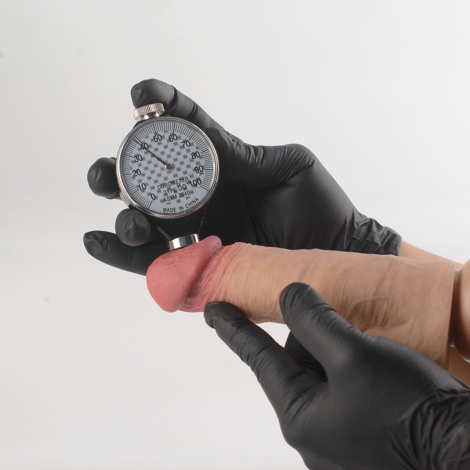 Stage 05 Carnotaurus dual-density silicone dildo with Velvet Shield Coating - Shore 00 durometer Type OO ASTM 2240 hardness test on glans showing 38 Shore 00 softness rating - scientifically verified ultra-soft outer layer comparable to human tissue - dual-density body-safe platinum-cured | RealTouch Lab
