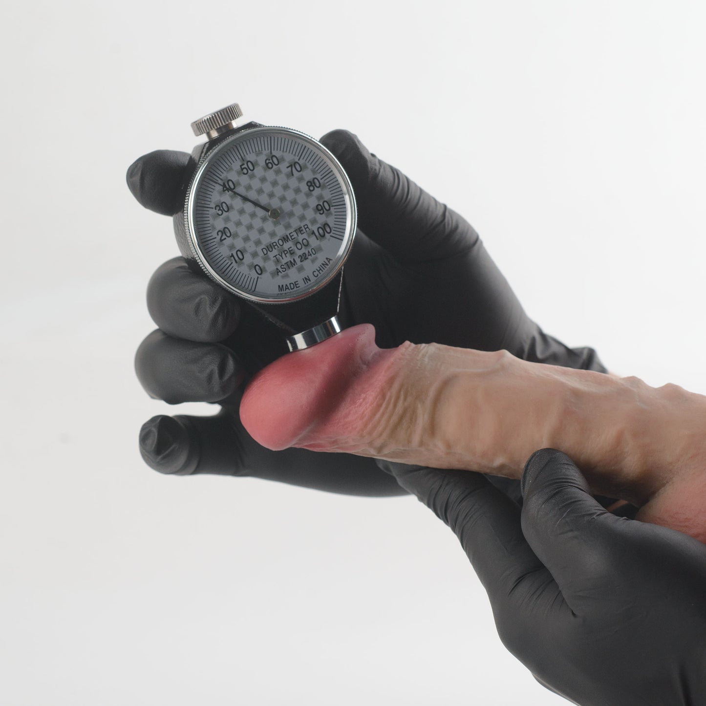 Stage 05 Velociraptor dual-density silicone dildo with Velvet Shield Coating - Shore 00 durometer Type OO ASTM 2240 hardness test on glans showing approximately 38 Shore 00 softness rating - scientifically verified ultra-soft outer layer comparable to human tissue - dual-density body-safe platinum-cured | RealTouch Lab
