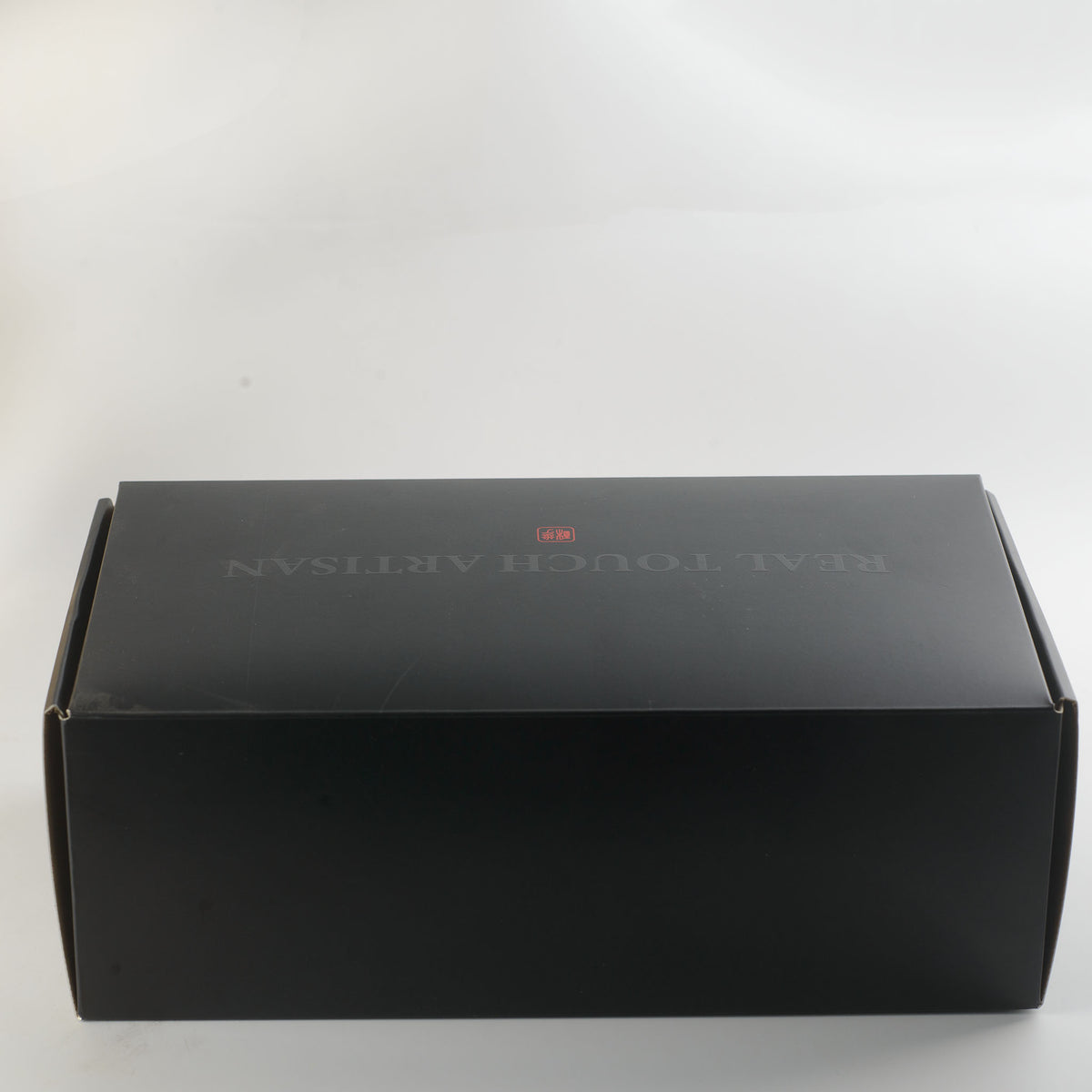 Stage 04 Velociraptor hand-painted silicone dildo - discreet matte black shipping box with subtle REAL TOUCH LAB branding and small red logo, no product description or category information on exterior for complete privacy - shipped in plain discreet packaging | RealTouch Lab
